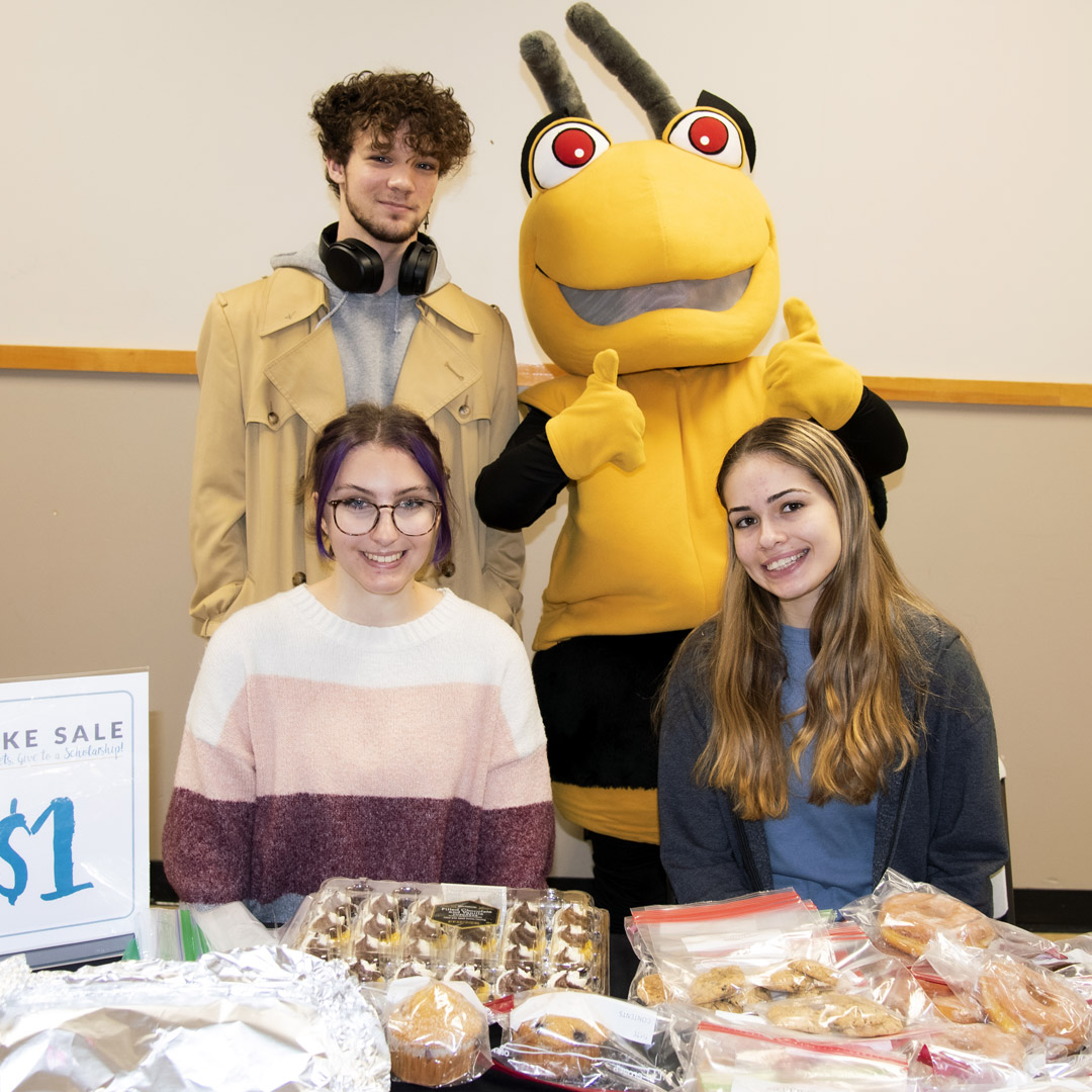 Students and Stinger at a Bakesale during 24 Hours of Giving 2023. 