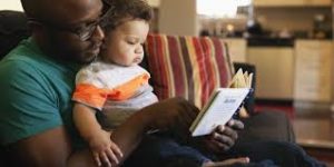 image of a father and baby reading together