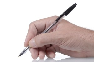 Hand holding a pen, ready to write
