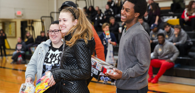 Students bring toys to donate to needy children.